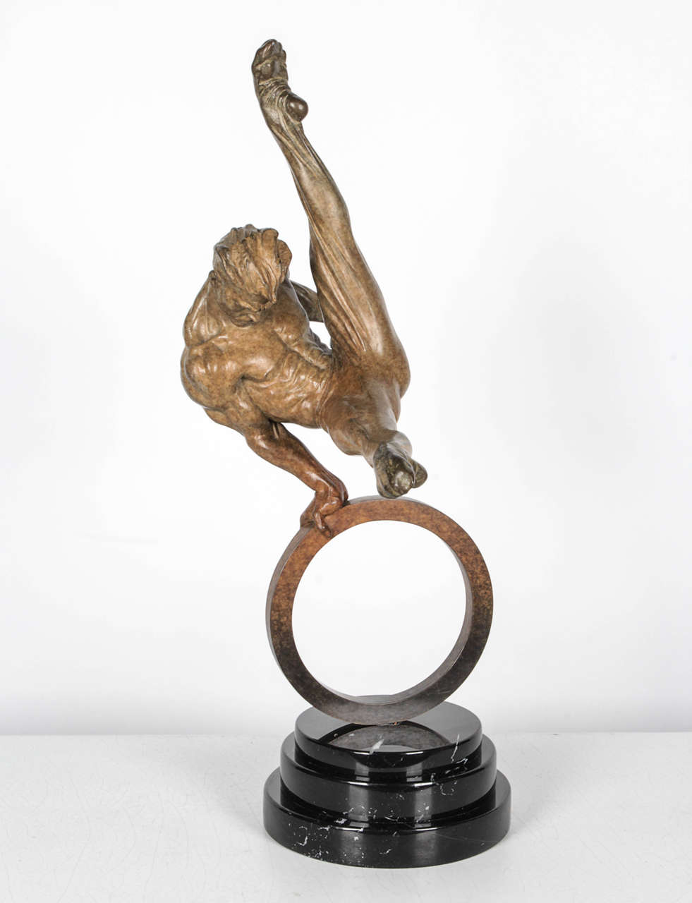 Bronze of a male rings gymnast. Sculpture sit atop a three-tier, black marble base.

From Art Brokerage: Richard MacDonald American Artist. Richard MacDonald will not allow art brokerage or his sellers to use his copyrighted images from books,