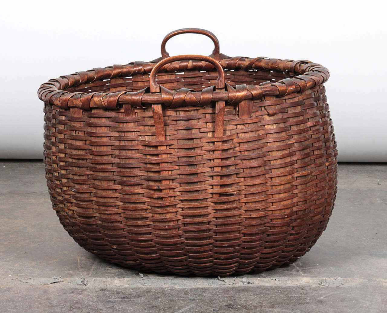 Woven basket from what appears to be black ashwood. Two small handles give ability to easily carry this fruit basket at your hip.

Not available for sale or to ship in the state of California.