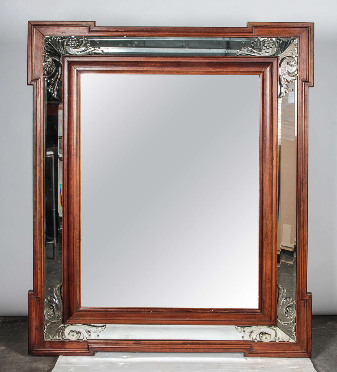 Art Deco mirror with beautiful scroll detail in mirror along frame edges. Wooden outer and inner edging adds depth and accentuates the deco design. Interior (main) mirror and edges are both beveled.

Not available for sale or to ship in the state