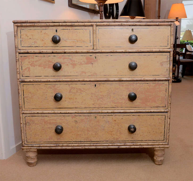 An outstanding 19th Century painted chest with original paint and stenciling, ebonized wooden knobs supported by bun feet.