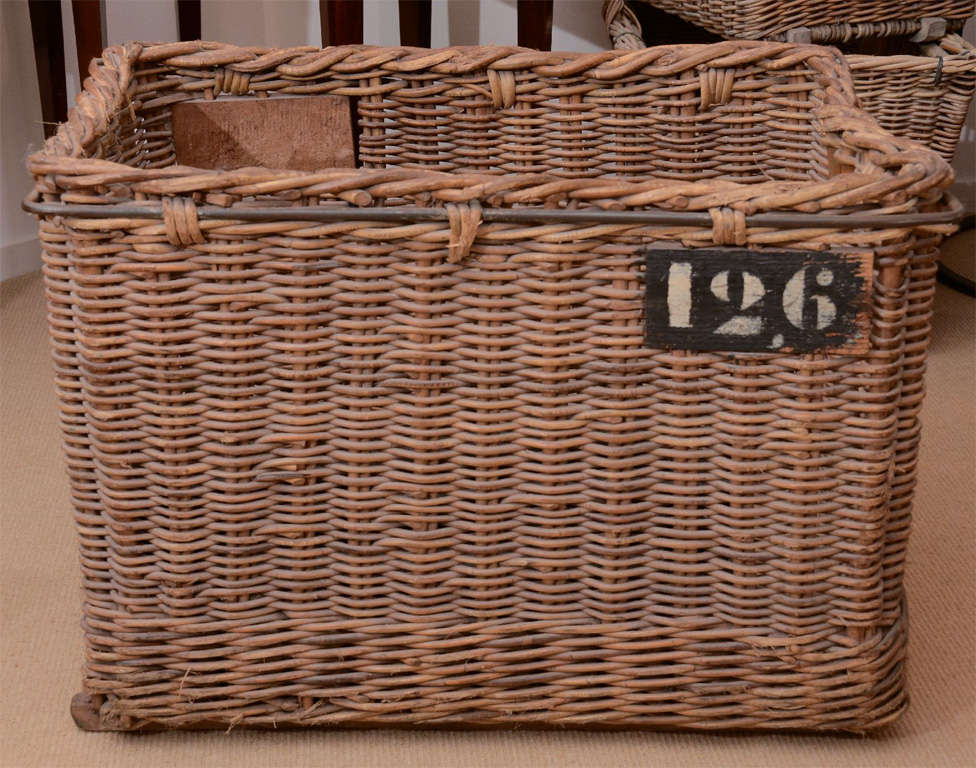 A turn-of-the-century wicker basket for carrying laundry, iron-bound numbered 126 - sturdy, perfect to hold logs for the fireplace.