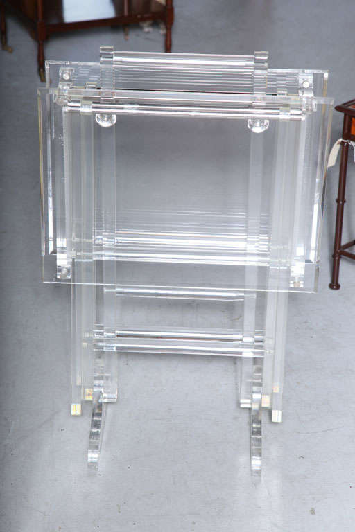 Vintage set of two folding lucite tables on a substantial stand.