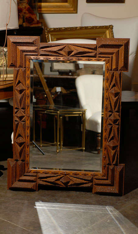 Large carved Tramp Art mirror with nice carving. Beveled mirror not original.