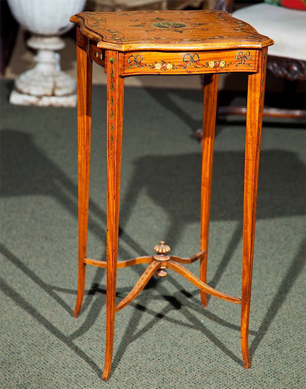 An English painted satinwood Adam style occasional table with tapered legs and finely painted decoration.