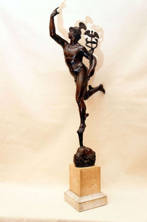 A very impressive Grand Tour Bronze of Mercury stand on the Wind carrying a Caduceus, while being mounted on a two color marble Base.