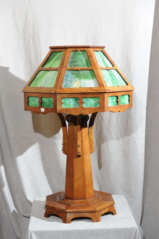 This beautiful golden mahogany wood and green slag glass table lamp is a very imposing and fine example of the arts and crafts style.  The shade portion easily separates in half for safe transport and seats firmly on the base when in use.  The rich