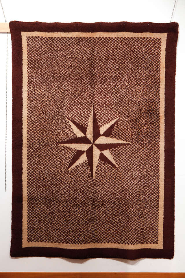 Distinguished by an eight-pointed star dominating a salt-and-pepper ivory/brown open field, rugs of this quality are referred to as 'travail domestique', as they were often woven in small, private workshops for their own use.