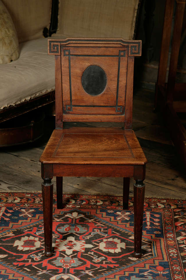 An exceptional set of three Grecian revival hall chairs