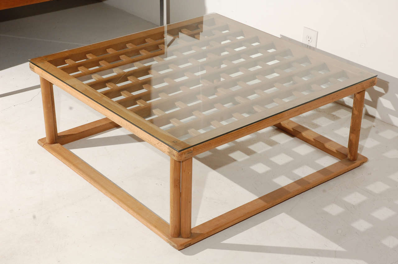 Japanese influenced low coffee table with lattice detail and glass top.