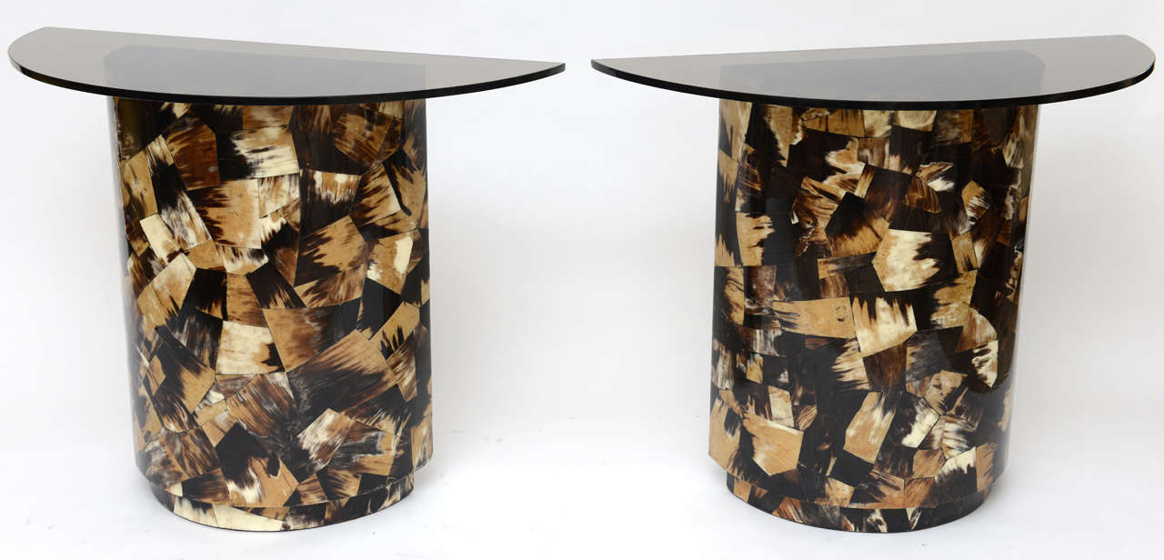 We love the crazy-quilt patchwork of genuine horn on this pair of pedestals. Semi-circles of half-inch smoked glass make them into demi-lune consoles, but - because they're finished in horn all around - they'd make a wonderful base for a desk,