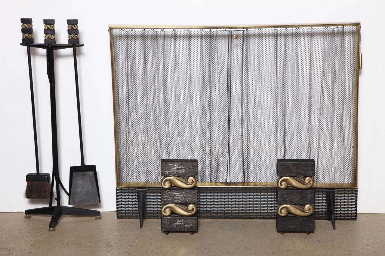 Modernist and classic Fleur de Lis design Bennett Co. Black Cast Iron, Bronze and Brass Fireplace Set.  The set features two Cast Iron and Bronze Firedogs (11.5H x 8W x 10D) Andirons, expandable wire mesh screen, and four-piece Cast Iron and Bronze