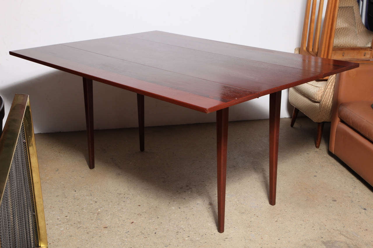 Mid Century Scandinavian Teak, Rosewood and Mahogany striped, drop leaf, folding, piano hinge Dining Table on tapered square legs.  Rich, deep color with 2 leaves measuring 12