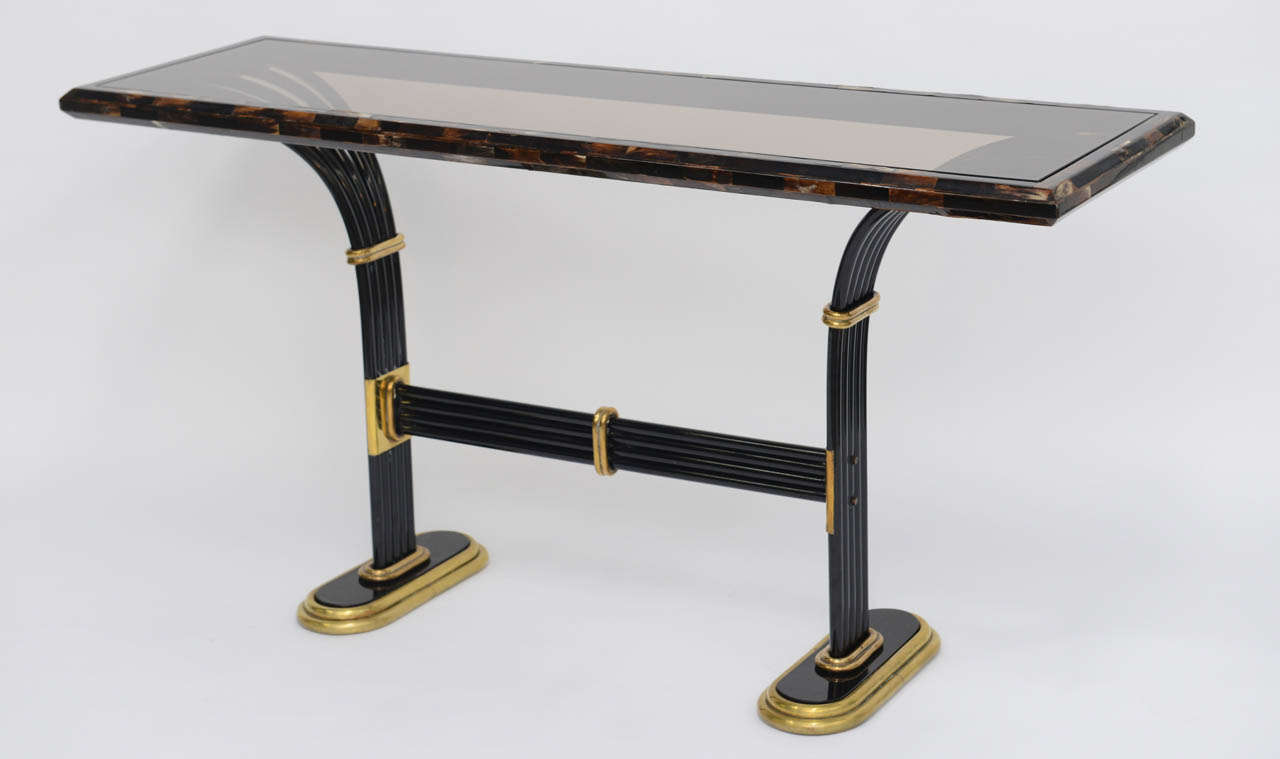 REDUCED FROM $4,500....Also exhibiting an Egyptian influence, this 1980s Karl Singer style console employs black lacquered wood and metal, solid brass mounts and beautiful tessellated horn with an inset smoked glass top.
Measurements:
59