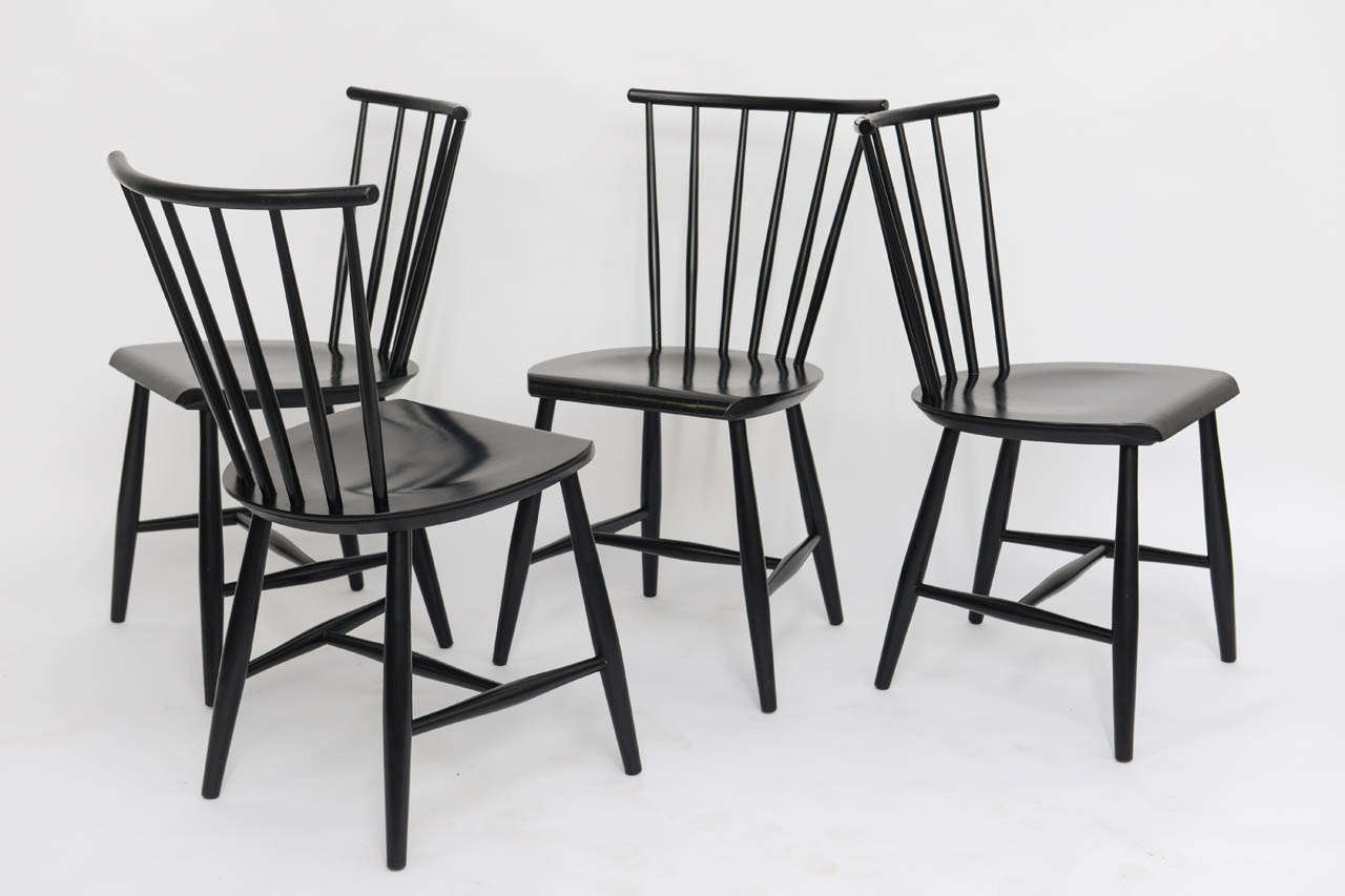 ...SOLD...With a nod to the Windsor chair, these four 1950s black ebonized chairs were made in Sweden.  Resembling as well the Ercol chair by Lucian Ercolani and others made in Denmark by Farstrup.  Great lean spindle back design.  Perfect for the