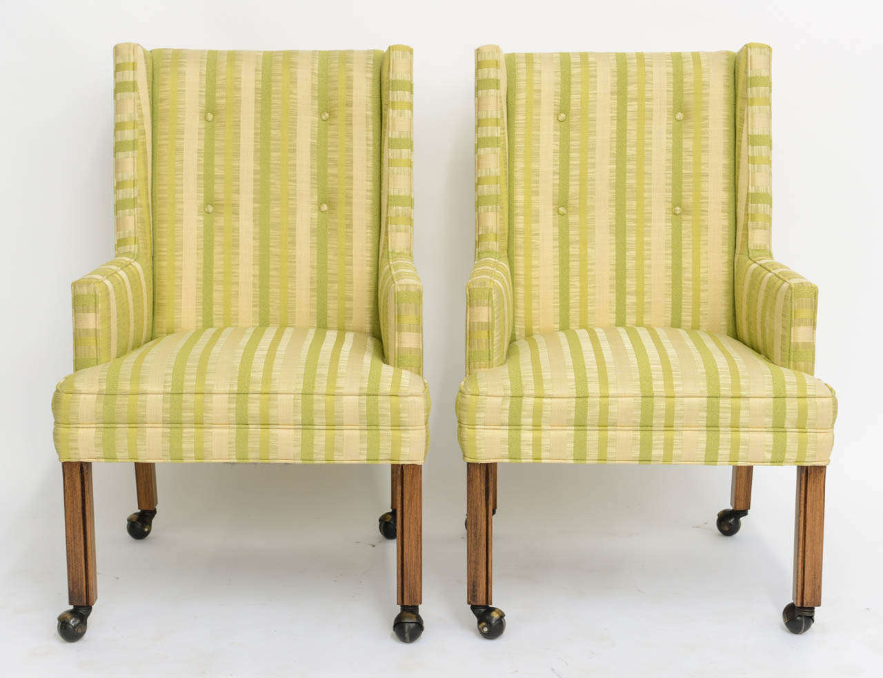 REDUCED FROM $1,950....Very tailored and regal, with button tuft back and on casters, this pair of high back armchairs in the style of Edward Wormley for Dunbar are quite smart. Very good original 1960s fabric with a couple of light small stains,