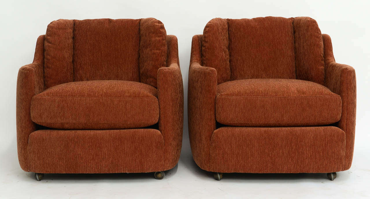 Sumptuous, cosy and most comfortable, this pair of Henredon Folio 500 Armchairs on casters have a wonderfull profile all around and great footprint.  Sculptural rounded shaping and deep cushions.  Reupholstered in a rust color soft chenille pinwale