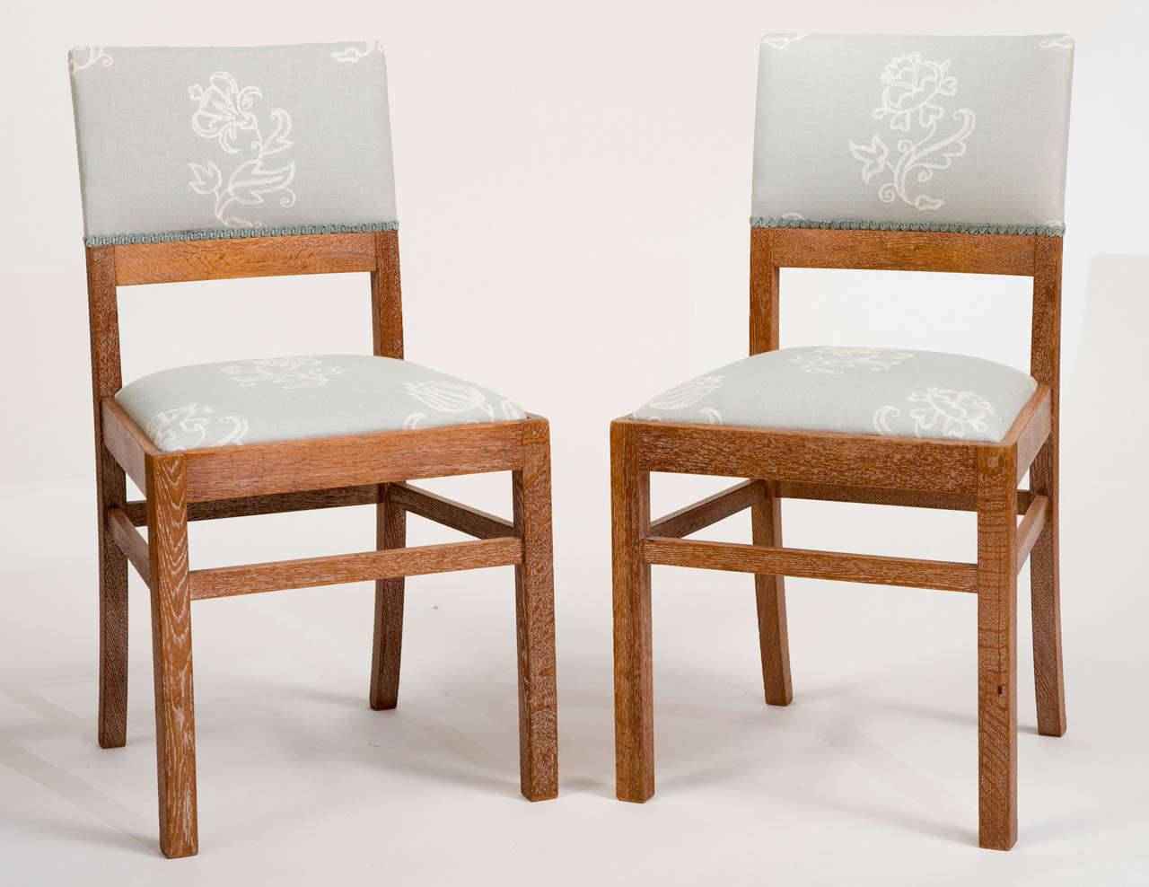 A pair of Limed Oak chairs by Heals and Sons, London.