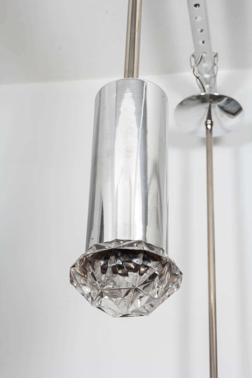 Fantastic pair of faceted glass pendants on polished nickel stems. When illuminated these give off a great ambient light. Each pendant requires one bulb.