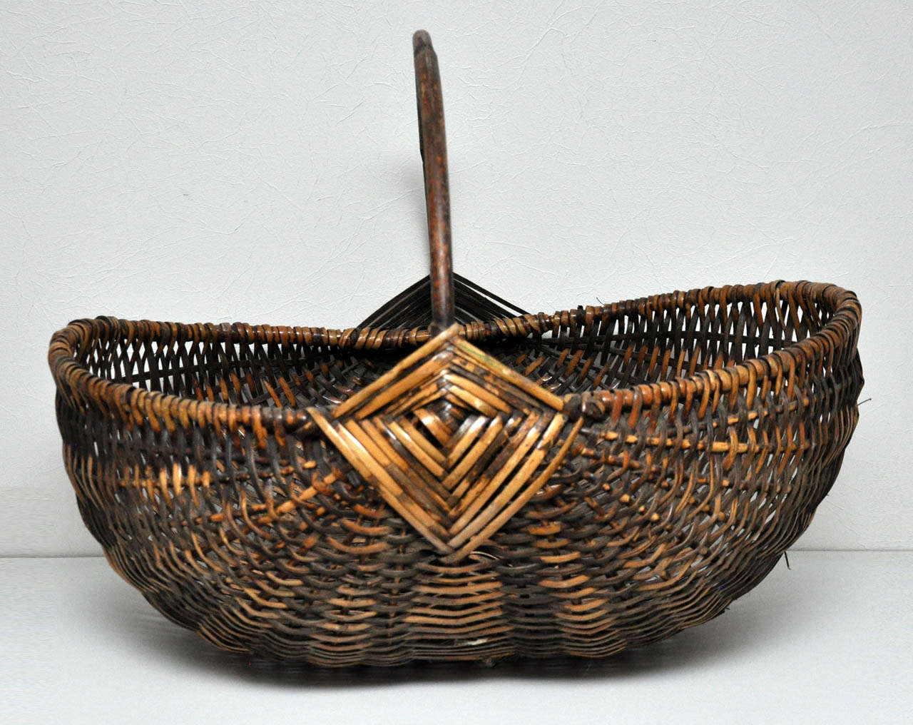 Beautifully detailed large scale hand woven basket with handle.
