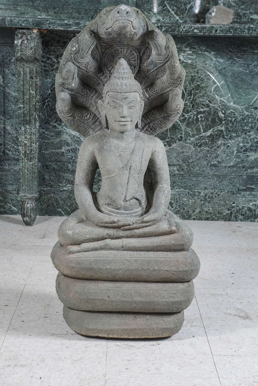 This sage green carved stone Buddha was purchased from an upstate NY garden where it has resided for the last 120 years. The family began the house and garden in the late 1890s and traveled through China, Southeast Asia and Europe acquiring objects