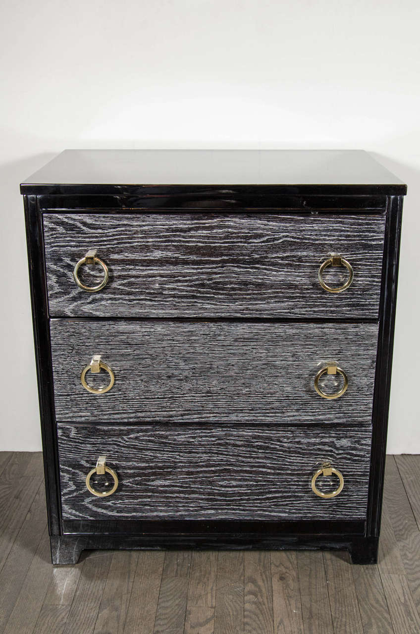 These gorgeous Mid-Century Modernist chests feature three spacious drawers with paired brass ring pulls, the silver cerused finish and contrasting ebonized trim give these chests a real edge that would compliment a variety of decor's. They would