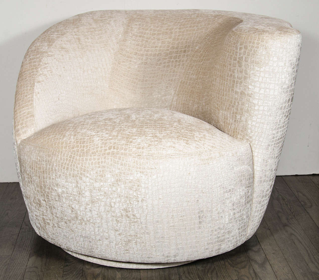 Sculptural pair of Mid-Century Nautilus swivel chairs by Vladimir Kagan. This pair of swivel chairs by Vladimir Kagan features a sculptural, asymmetrical design that starts at the top of the chairs slight scroll arm design then follows the sloping