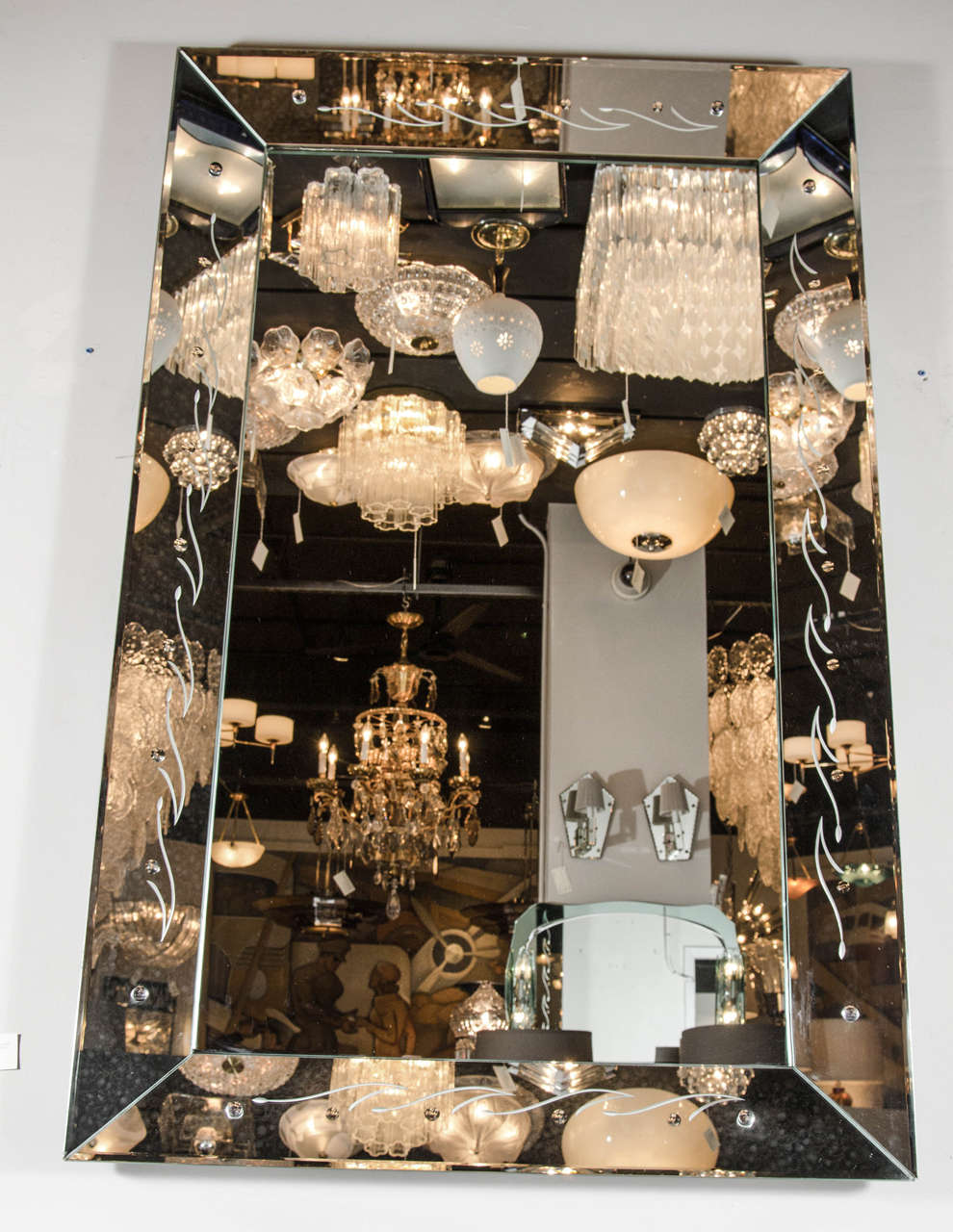 This sophisticated 1940's Hollywood hand beveled mirror features a shadowbox border with a fine stylistic design of lines. This mirror can be hung vertically or horizontally.