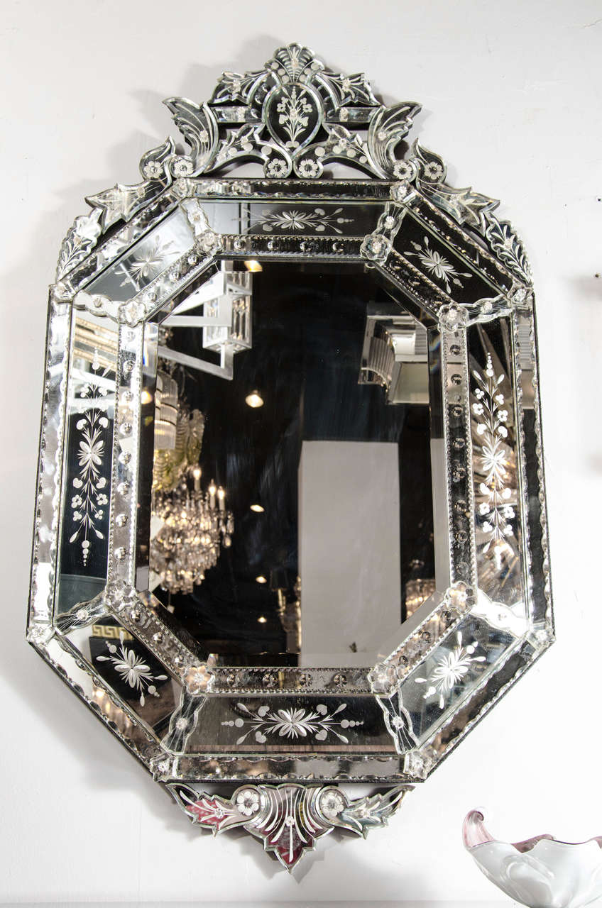 Outstanding, reverse etched and beveled, octagonal Venetian mirror. Reverse etched convex and floral detailing on the border and an extravagant upper cartouche. This spectacular piece will command attention wherever it may be. It is in excellent