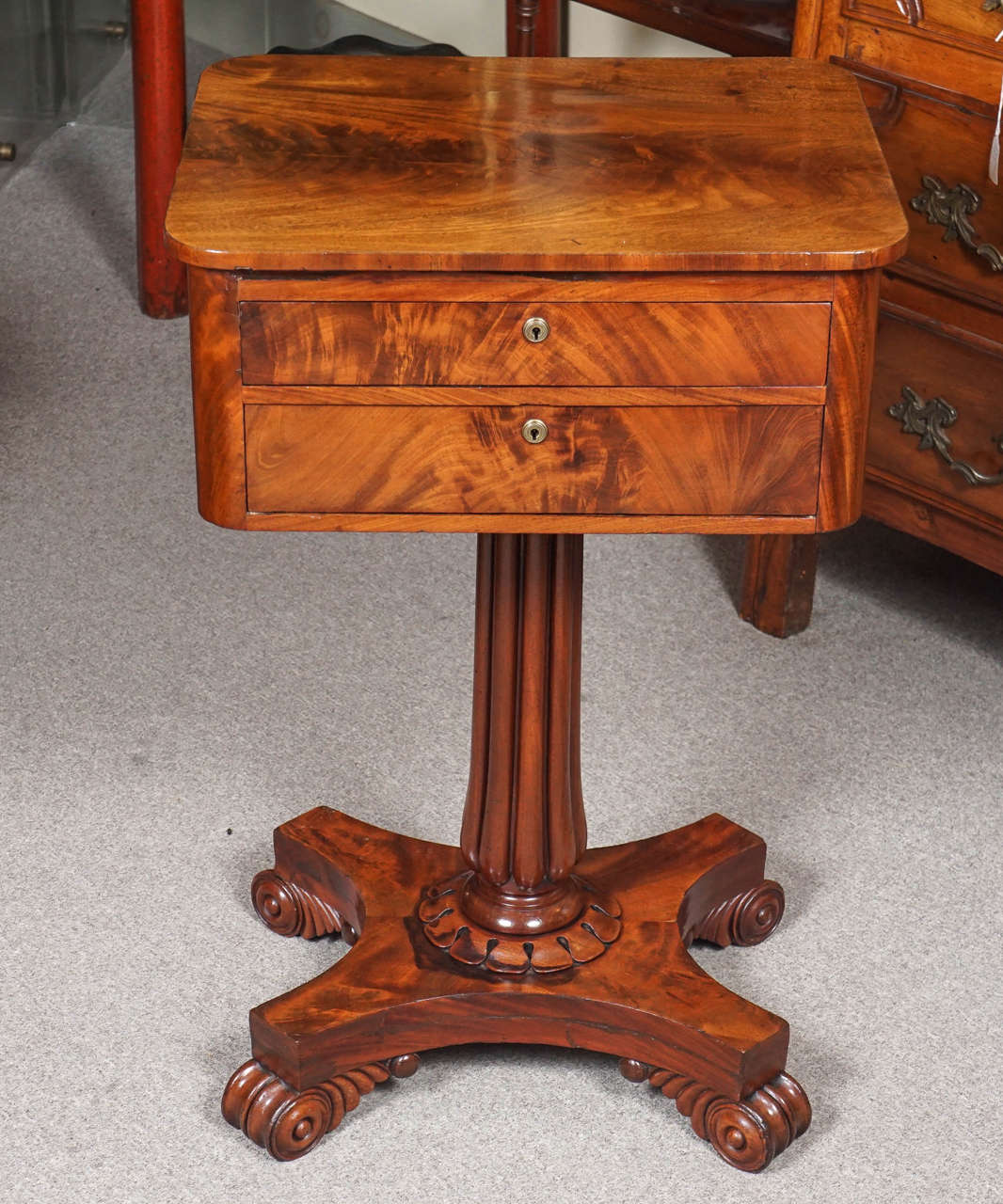 English mahogany work table with two drawers. Fluted pedestal base.