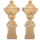 Pair of large garden urns on stands with lids.