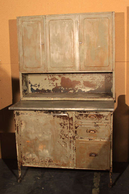 Very unique, metal kitchen queen or step back cabinet with metal top serving area.  Rust and paint patina gives a warm beauty to this industrial piece. Original hardware, would make a great side bar.