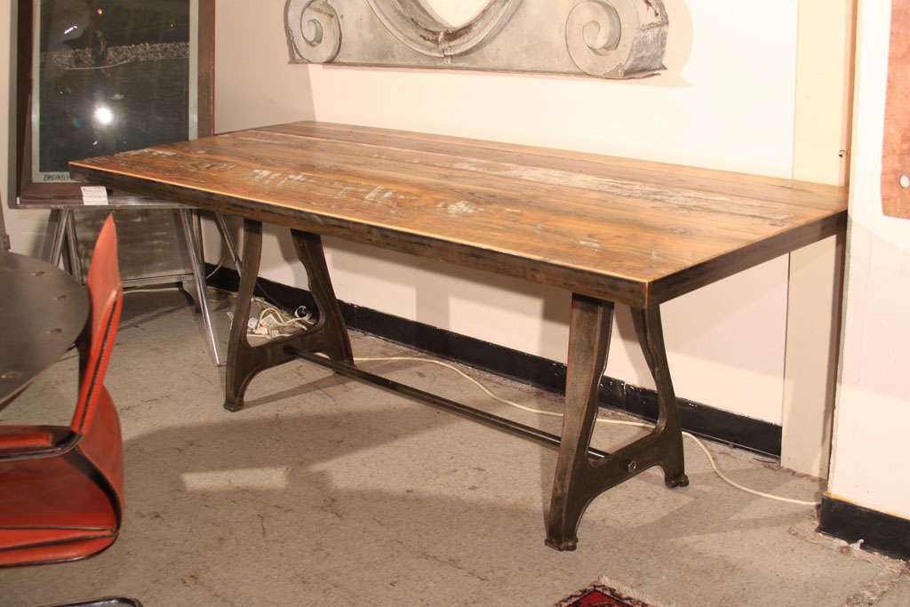 Barnwood dining table with industrial machine legs.  Crosscuts and paint in wood give character to this piece.