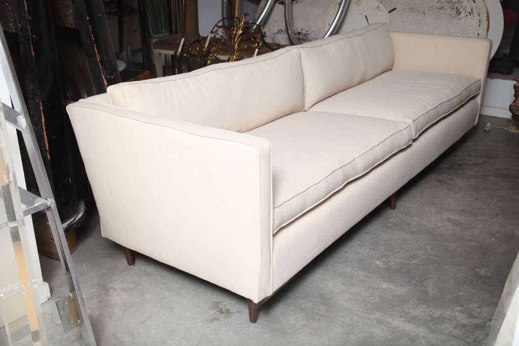 WOOD FRAME WITH UPHOLSTERED LOOSE CUSHIONS AND WOOD LEGS.SOFA WAS COMPLETELY REFURBISHED.