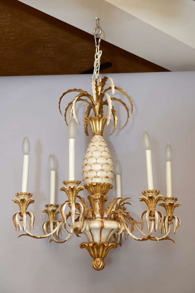 Chandelier, having center column of painted wood carved as a pineapple, surmounted by a sprig of gilded leaves, six S-scroll gilded iron candlearms terminating in leafy bobeches.