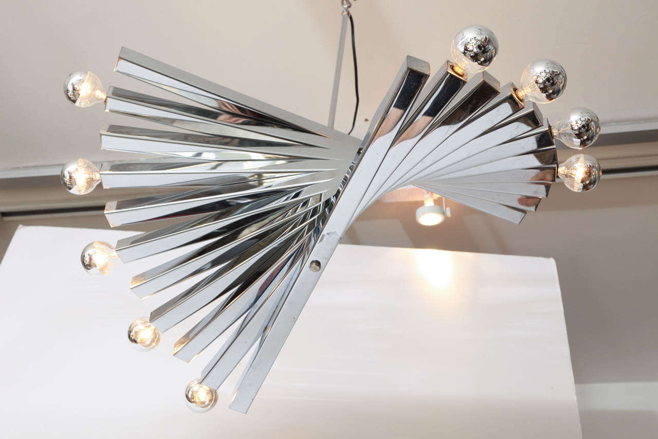 Spiral chrome, midcentury chandelier by Gaetano Sciolari, Italy, circa 1960. The chandelier is made of square steel bars forming a partial spiral. It takes ten lights bulbs. The body of the chandelier is 11 inches high. Excellent vintage condition.