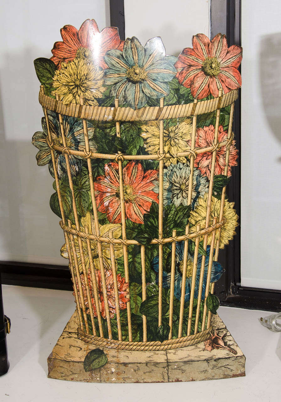 A Piero Fornasetti open umbrella stand, 1960s, decorated with flowers in a basket.