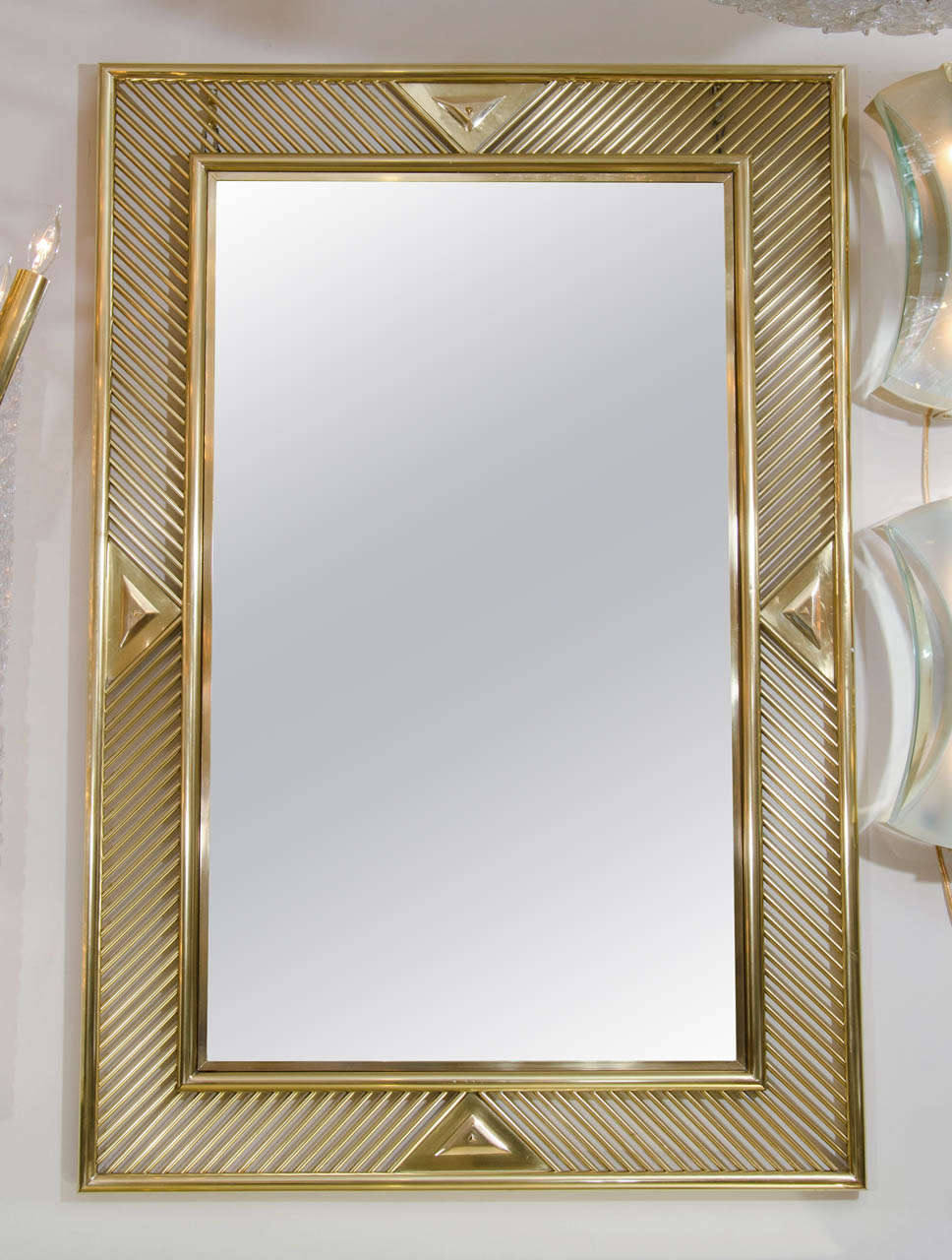 Rectangular brass mirror with openwork geometric surround.
