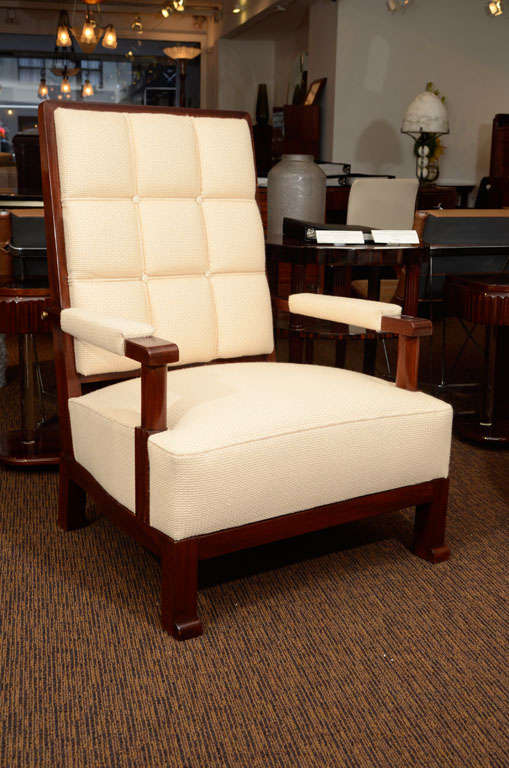 A pair of stained wood open armchairs in the manner of Paul Dupre-Lafon with cream woven fabric.