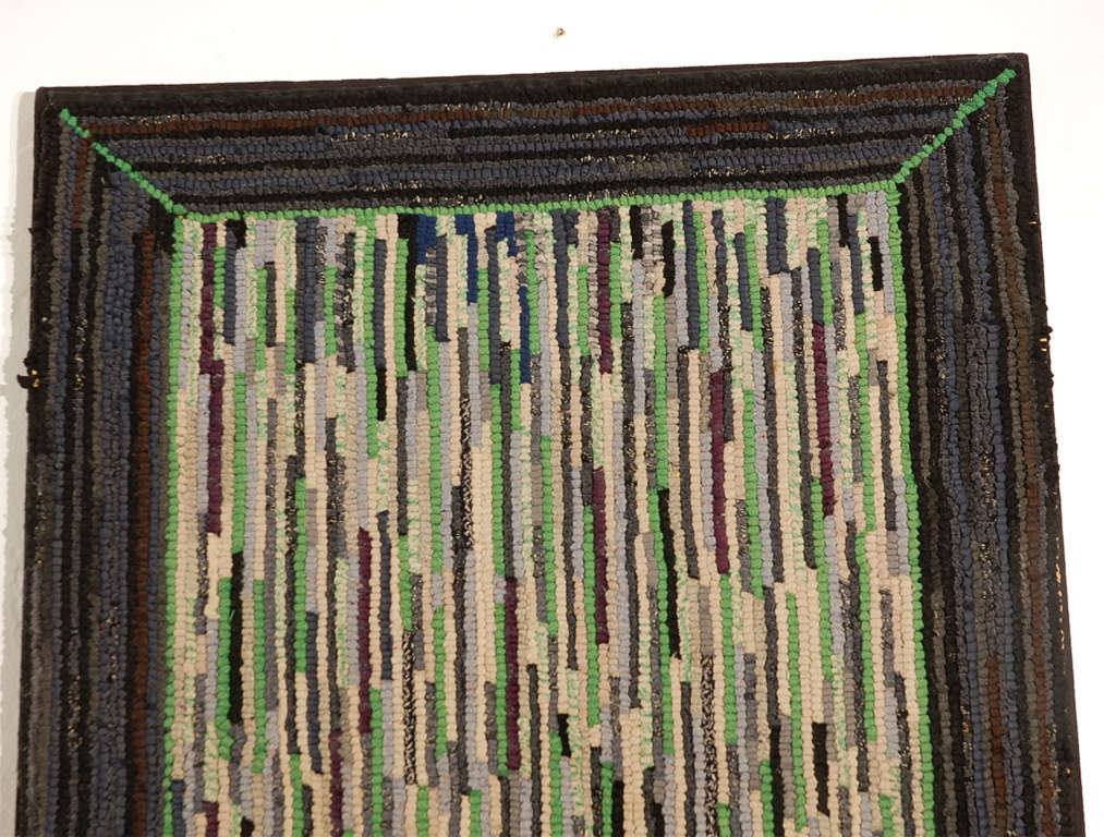 This unusual simple yet some what modernist pattern Amish hand-hooked rug is in fantastic colors and condition. This wonderful black/grey border follows through the body of the rug with black, grey and green colors. Ready for hanging.