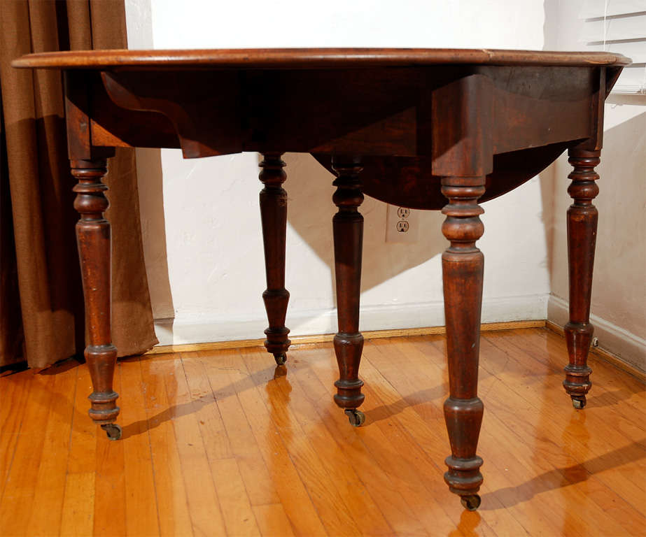 Fantastic 19thc original worn surface oval drop leaf table with original casters and turned legs.This wonderful drop leaf table comes from a farmhouse in Pennsylvania .The table has the most wonderful patina and great country charm.The condition is