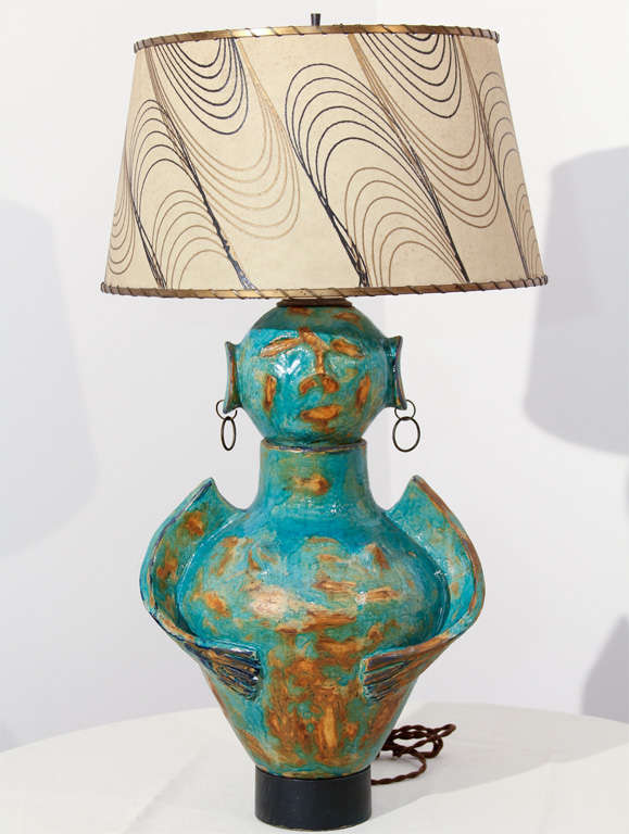 There is certainly nothing else quite like this gender confused original ceramic lamp.  It sports a beautiful blue fired glaze, double hoop earrings, wings and breasts.  What's not to love?  The shade is vintage and it has been professionally
