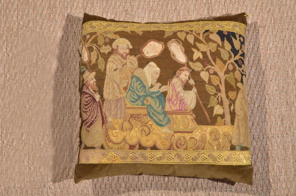 This unique Antique tapestry depicts a scene which looks to be The 3 Wiseman at the birth of Jesus. Also depicted in the center is Jesus' Father Joseph. The colorful tapestry is made into a custom pillow, framed by antique metallic ribbon. This is