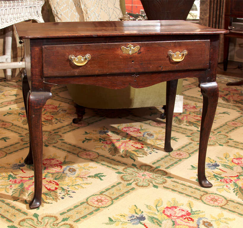 English oak country lowboy, early Georgian. Pointed toes on pad feet, original hardware.

OFFERED AT THIS 50% OFF PRICE FOR 2015 ONLY!
