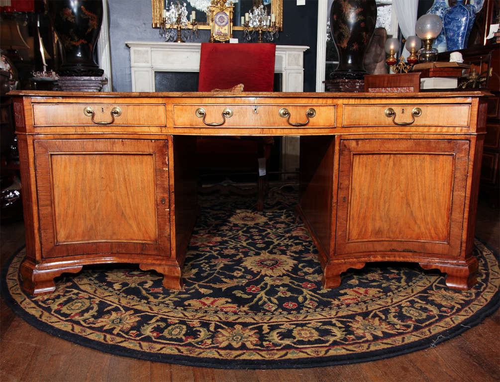 English, George III style, late 19th century. Large sage green leather topped mahogany desk with a serpentine shape. As well as hand tooled edging around the top.