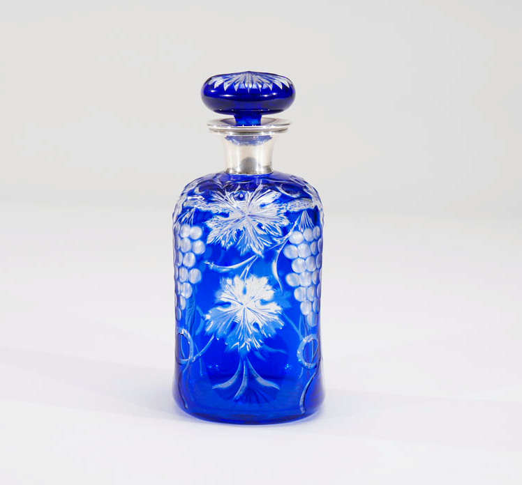 This vibrant blue decanter is made by Stevens and Williams and features cobalt blue overlay cut to clear in the 