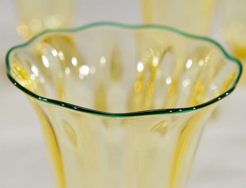 This is a stunning set of 12 hand blown optic ribbed crystal tumblers made by Victor Durand who worked for L.C. Tiffany before opening his own factory in Vineland, NJ. Each one is uniquely shaped in an Art Nouveau style floriform motif. The