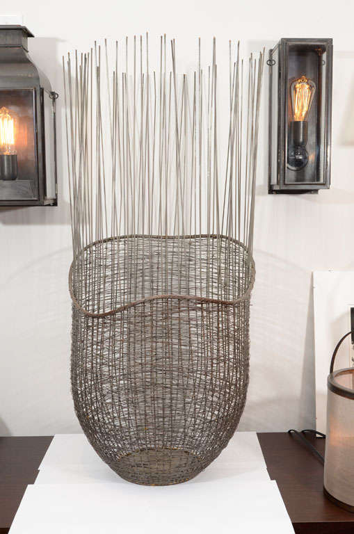 Quill basket made of woven metal creates unique textures for aesthetic and function simplicity.