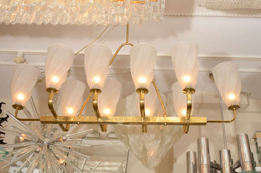 Large linear brass chandelier with twisted bobeches