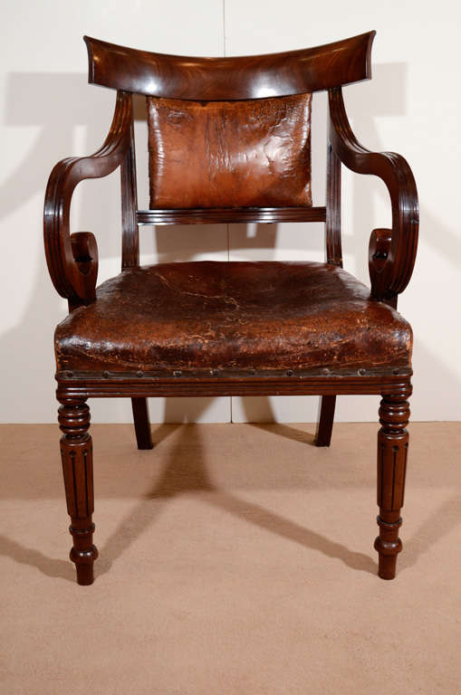 A George IV mahogany desk chair
with leather seat and padded back
circa 1825
