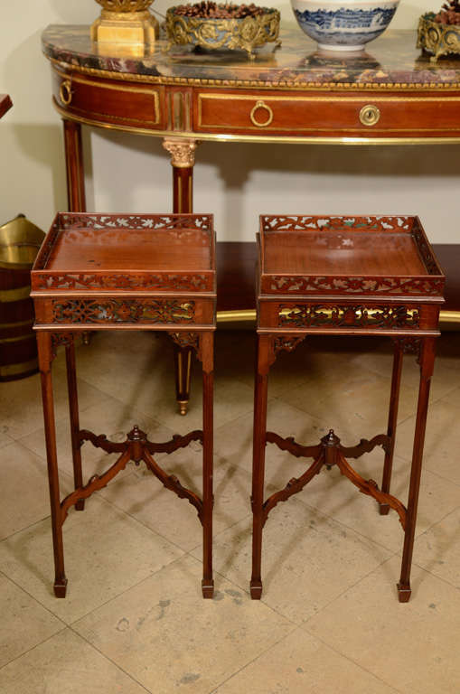 A pair of George III mahogany carved open fret work urn stands. 